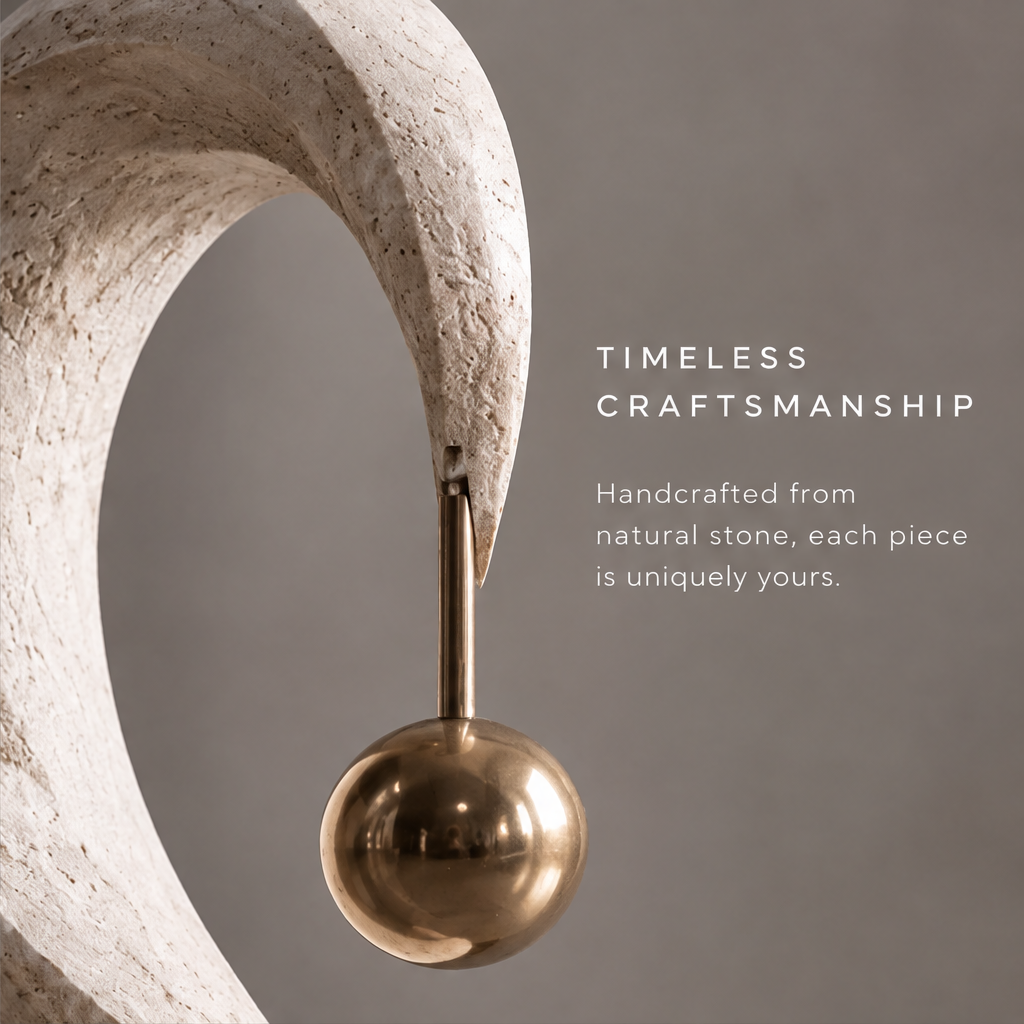 HOMZURE sweeping open curve and hanging gold-tone ball viewed from the front