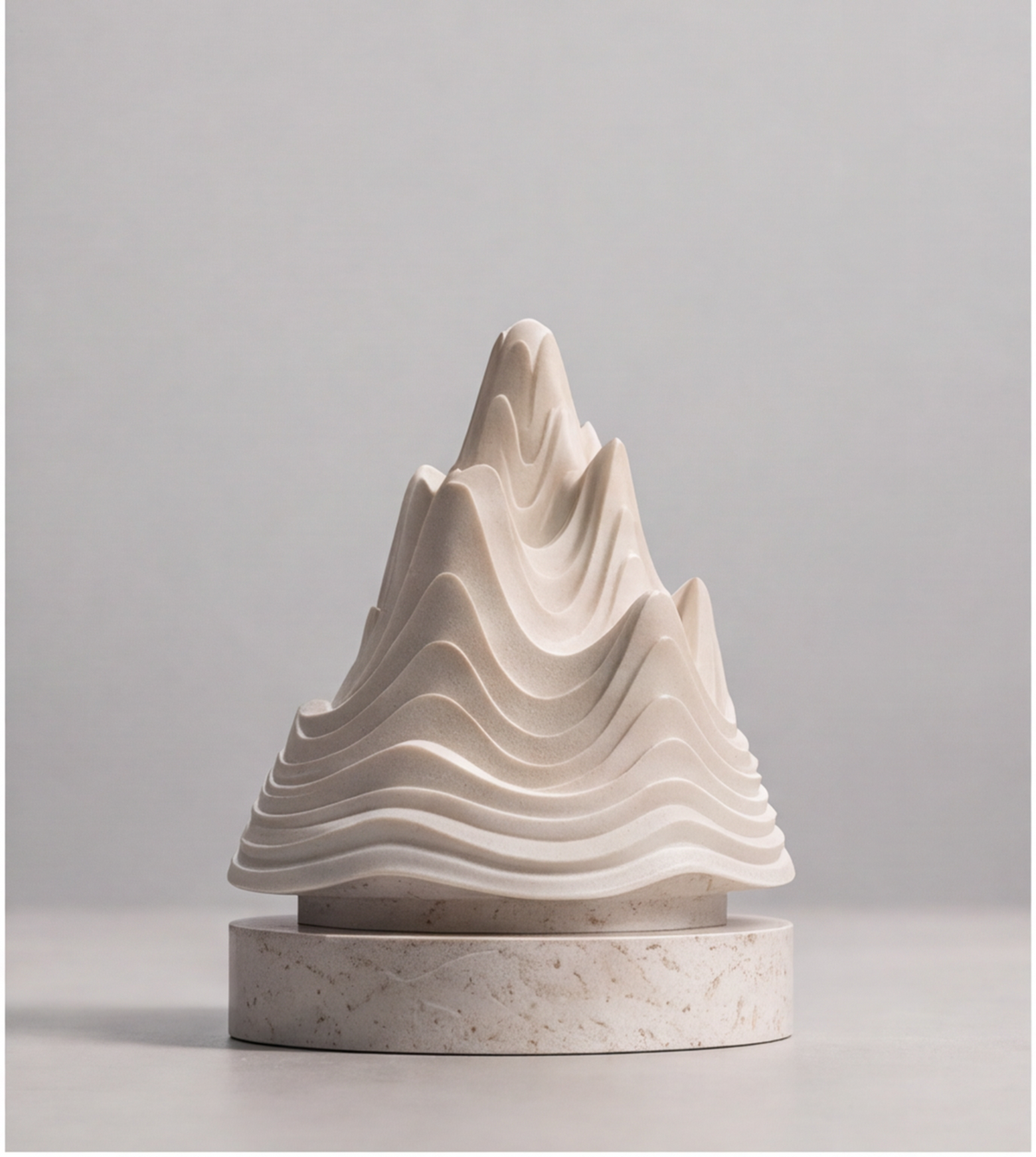 HOMZURE layered mountain sculpture displayed on a console with books and framed artwork