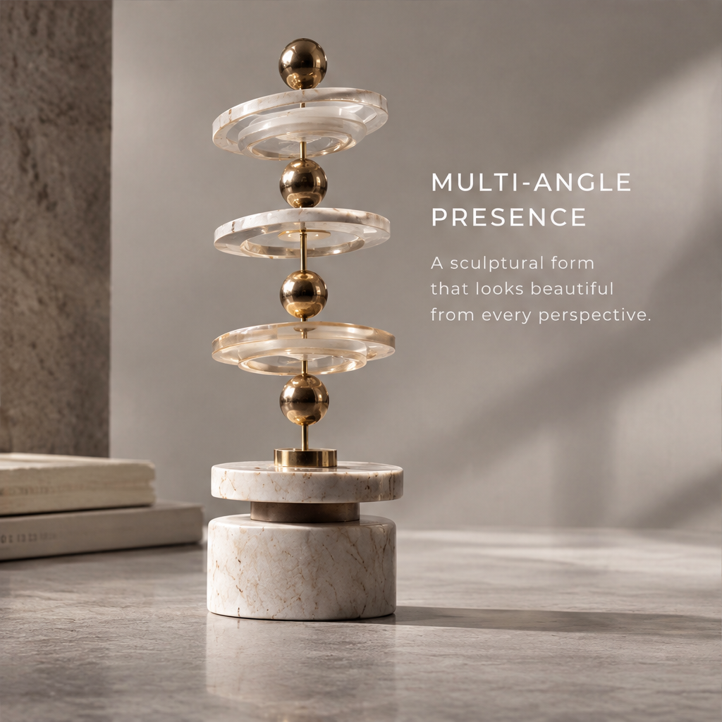 Close-up of the HOMZURE sculpture base with pale veining and gold-tone sphere
