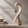 HOMZURE pale textured curved sculpture with a hanging gold-tone sphere on a square base against a plain background
