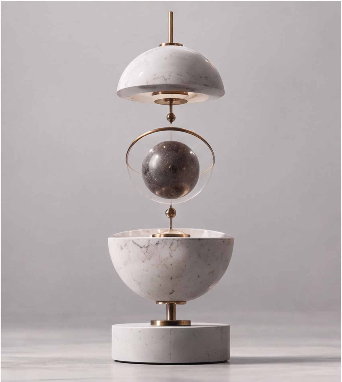 Close-up of the pale veined upper form, gold-tone ring and dark globe in the HOMZURE sculpture